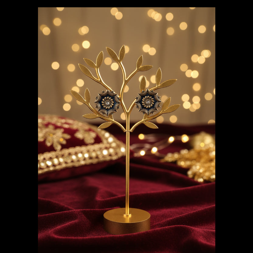 A pair of vintage-style gold-toned brooch pins with dark blue enamel detailing and a central clear crystal, displayed on a white card labeled 'Fashion Jewelry' and resting on a gray textured fabric surface.