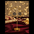 A pair of vintage-style gold-toned brooch pins with dark blue enamel detailing and a central clear crystal, displayed on a white card labeled 'Fashion Jewelry' and resting on a gray textured fabric surface.