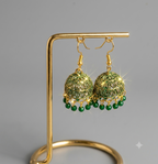 Close-up of the gold-tone fish-hook loop closure on a Green Jhumki earring, handcrafted by Chokhi Creations.