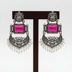 A pair of silver-toned traditional Indian chandelier earrings with rectangular pink gemstones and white pearl bead fringe, displayed on a white card labeled 'Fashion Jewellery'.