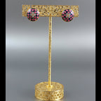 A pair of pink and blue round Meenakari Kundan stud earrings with floral enamel detailing.