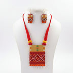 Handpainted terracotta necklace set on a white bust, red thread with a rectangular red, gold and white patterned pendant and matching drop earrings