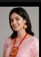 A handcrafted Terracotta Square Necklace Set in orange and gold, displayed with matching earrings.
